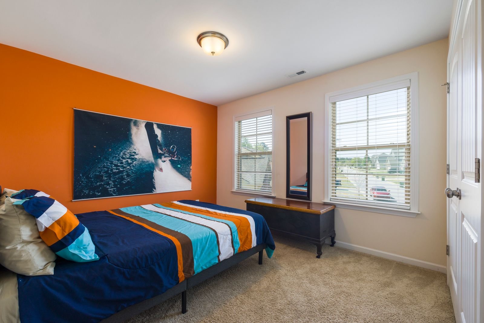 Bedroom with an orange accent wall