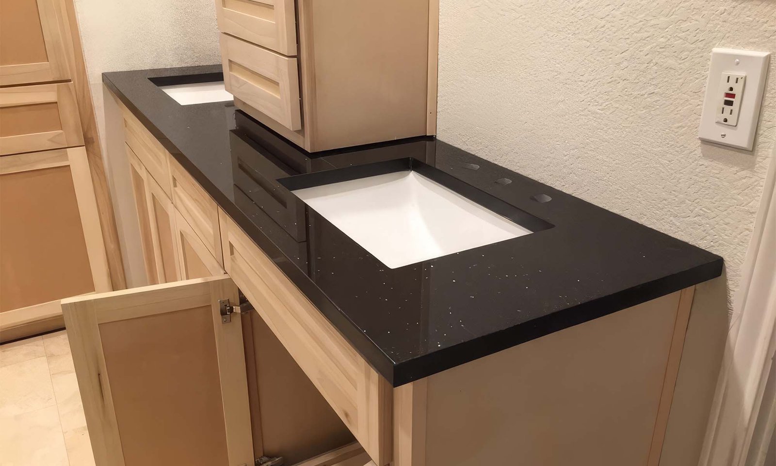 Black quartz vanity top with undermount sinks